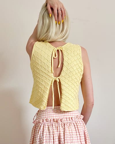 The Diamond Tie Vest, hand-knitted by an independent maker, worn
